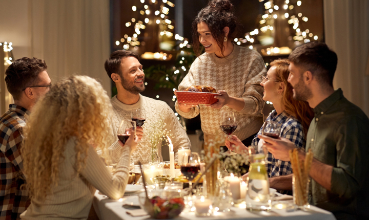 Familia sentada en una mesa, celebrando el Día de Acción de Gracias